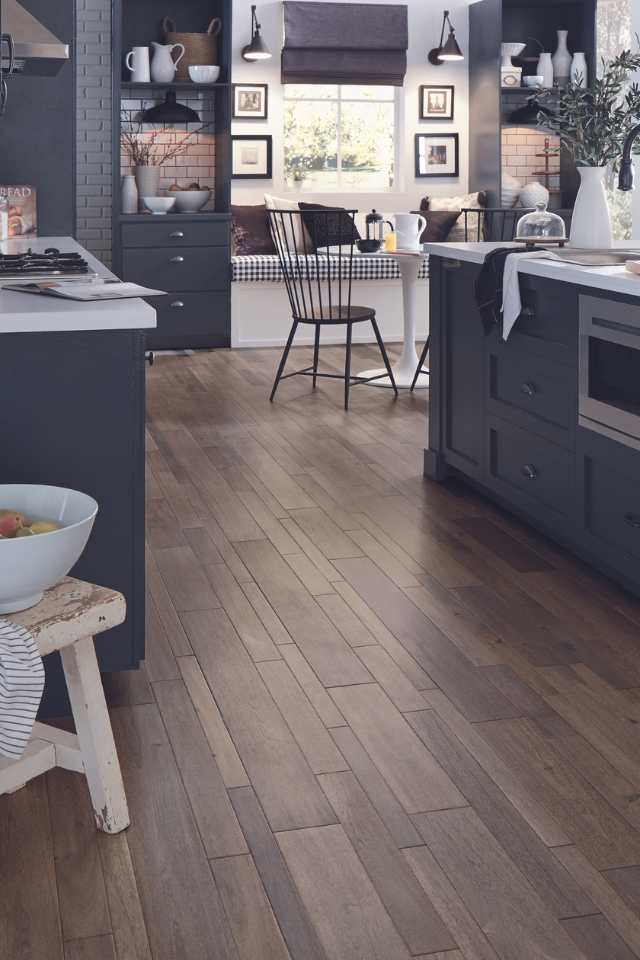 farmhouse style cabin kitchen with plaid breakfast nook and original hardwood flooring